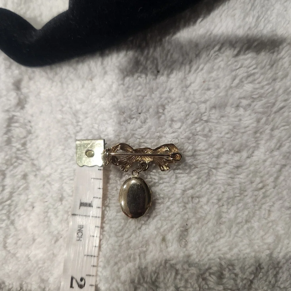 Vintage Gold Tone Bow Brooch with Engraved Floral Oval Dangle Locket Pin